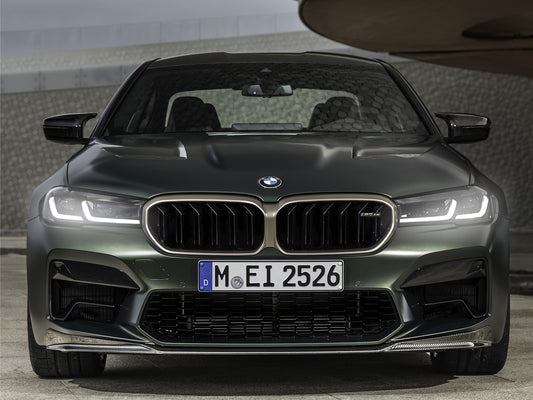 BMW M5 CS neon LED light frame wall art glowing vividly in a dark room setting