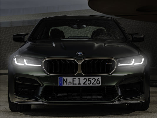 BMW M5 CS neon LED light frame wall art glowing vividly in a dark room setting